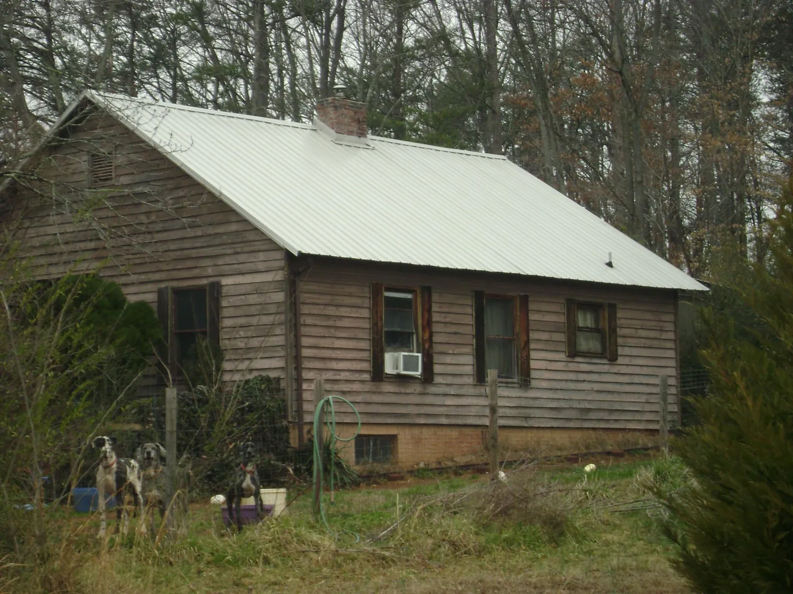 White metal roof on an old wood sided farmhouse, from a Metal Roof Installation job in Sperry